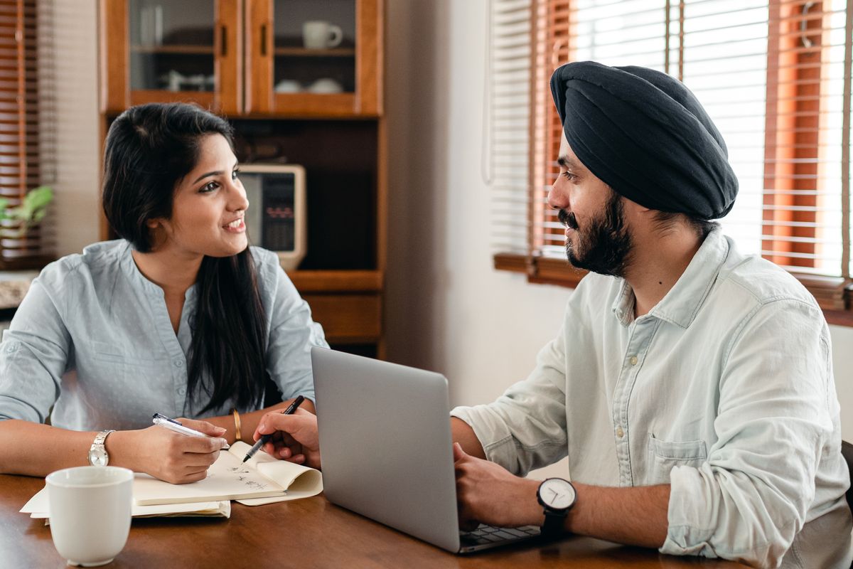 Two colleagues comparing options on a laptop