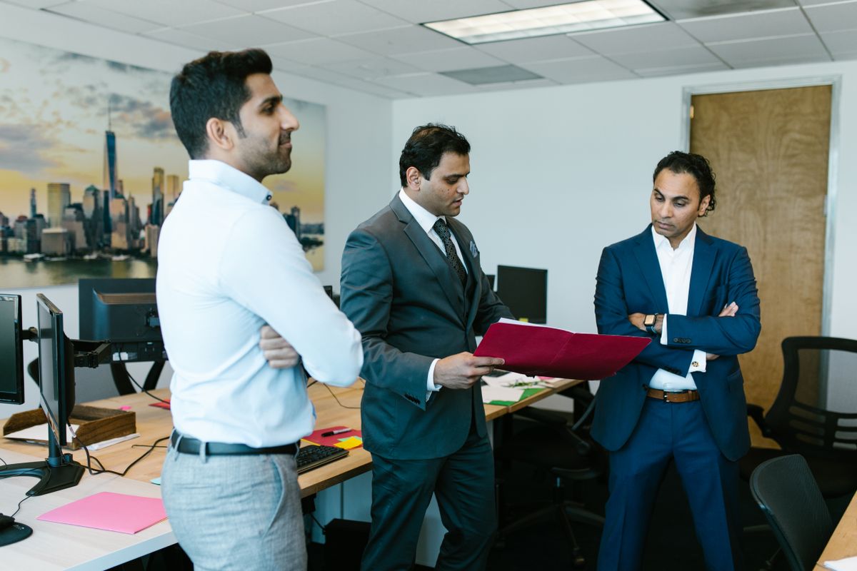 Colleagues reviewing compliance documents in an office