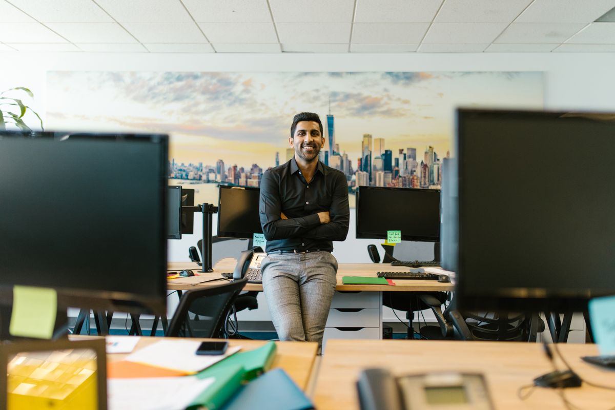 Manager relaxed at his desk in a busy office