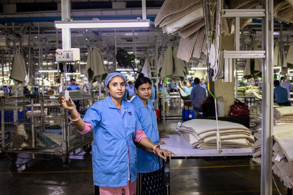 Indian textile factory workers at a loom station