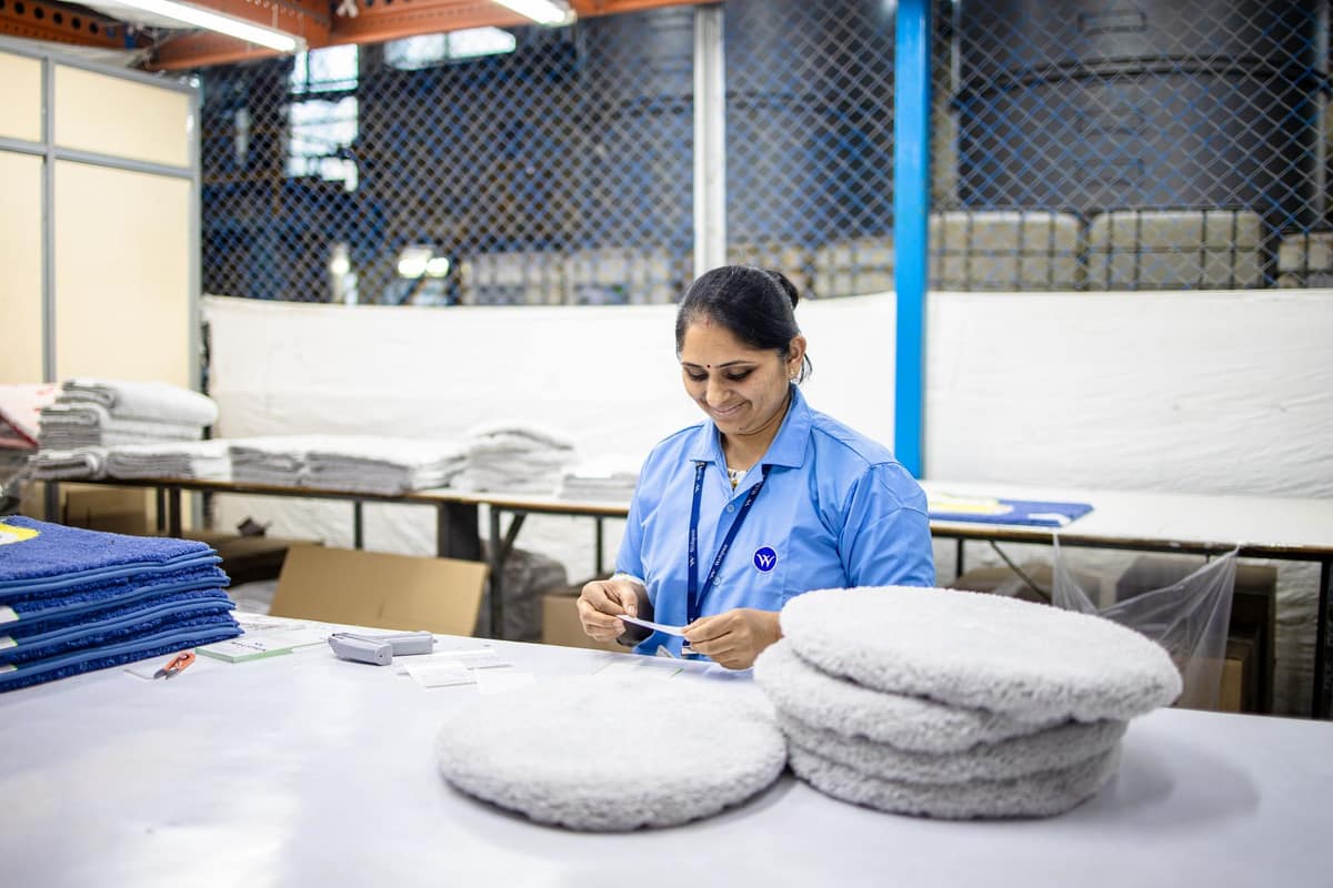 Factory worker counting stock in an Indian warehouse