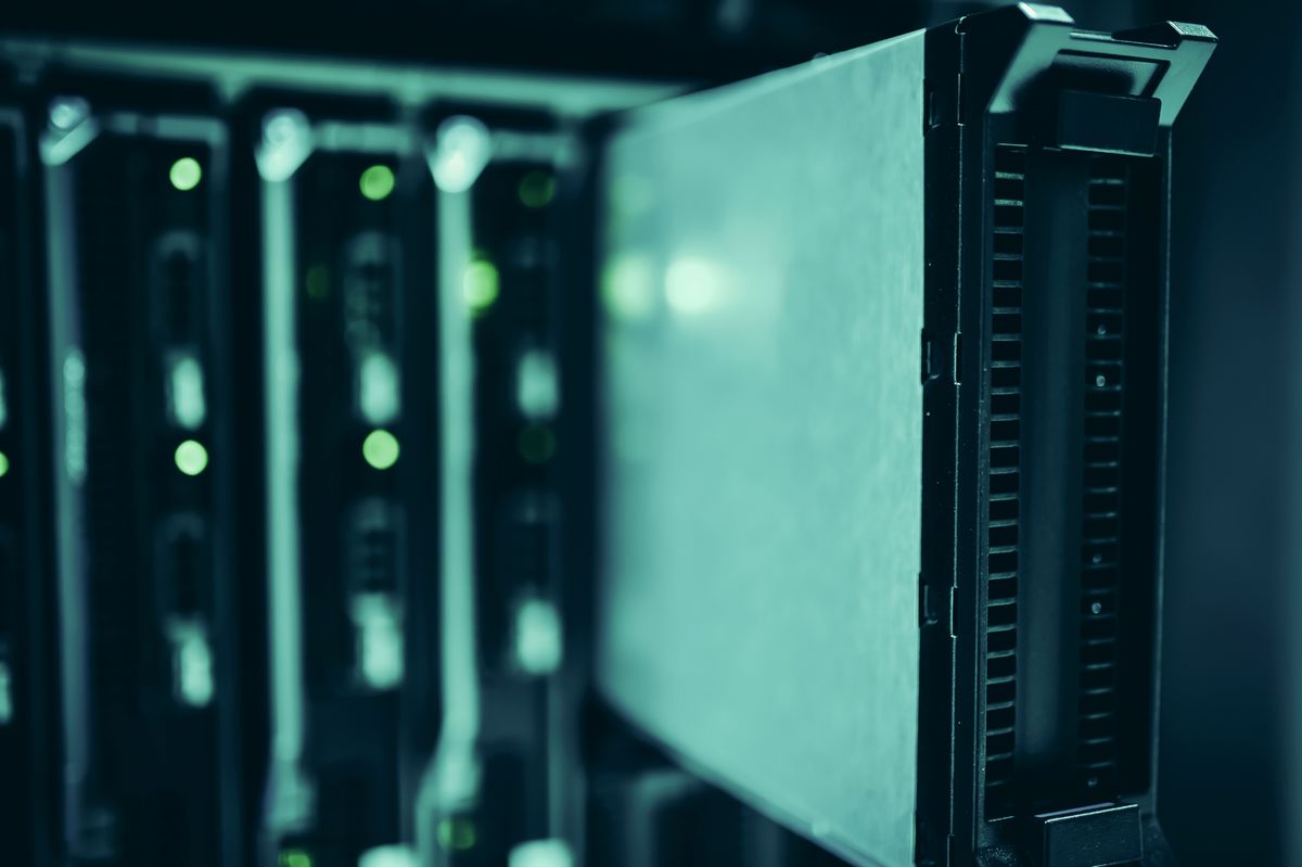 Rows of server racks with lights in a data center
