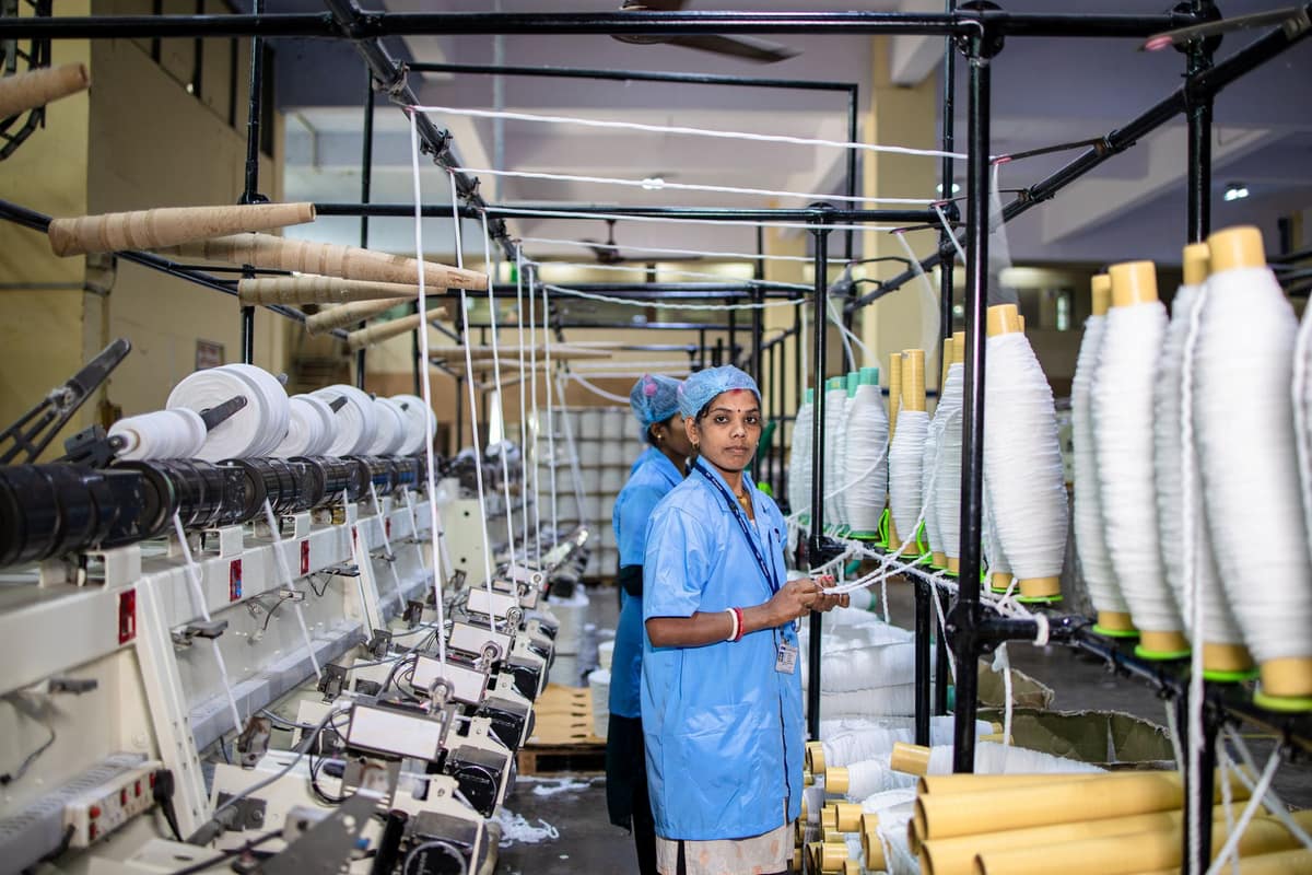 Workers running spinning machines on an Indian factory floor, plant and machinery that is depreciated each year