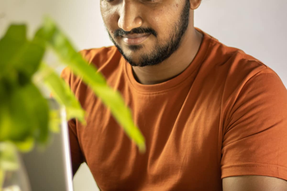 Indian employee working on a laptop, planning retirement savings