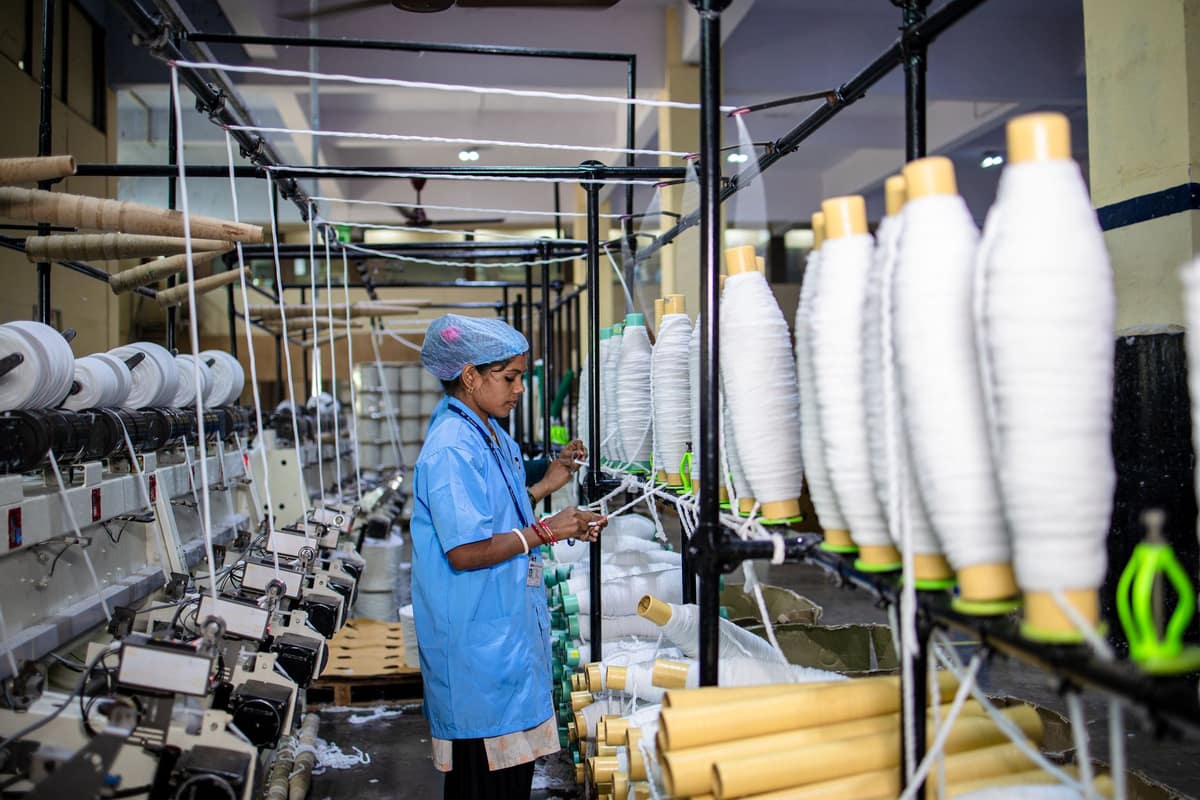 Worker managing machinery in an Indian textile factory