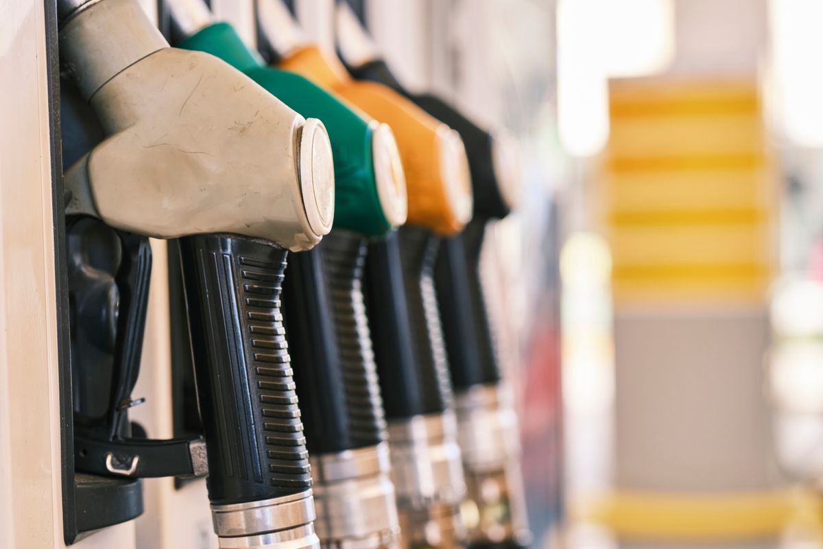 Close-up shot of colorful gas pump nozzles at a fuel station.