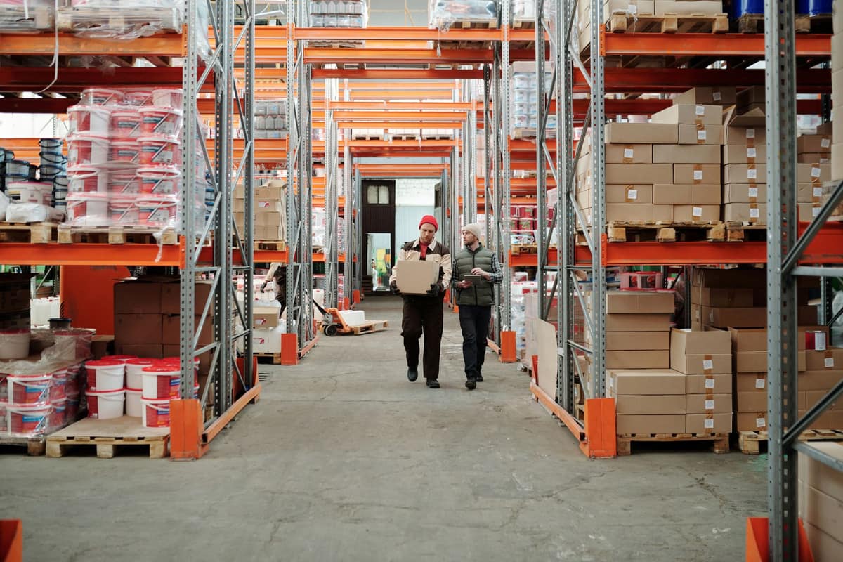 Workers walking through a large distribution warehouse