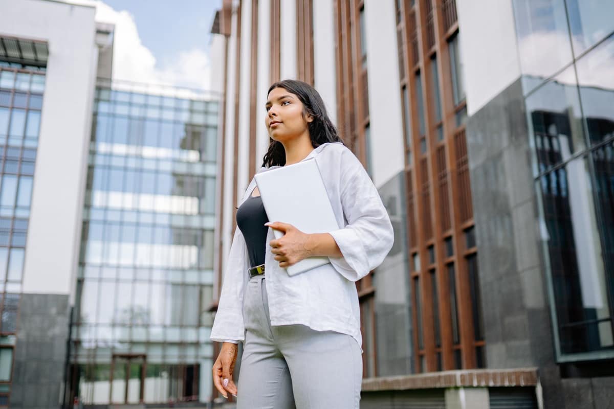 Indian businesswoman travelling for work outside an office building
