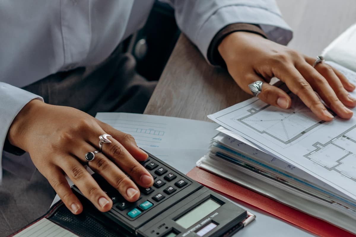 Accountant working through figures with a calculator