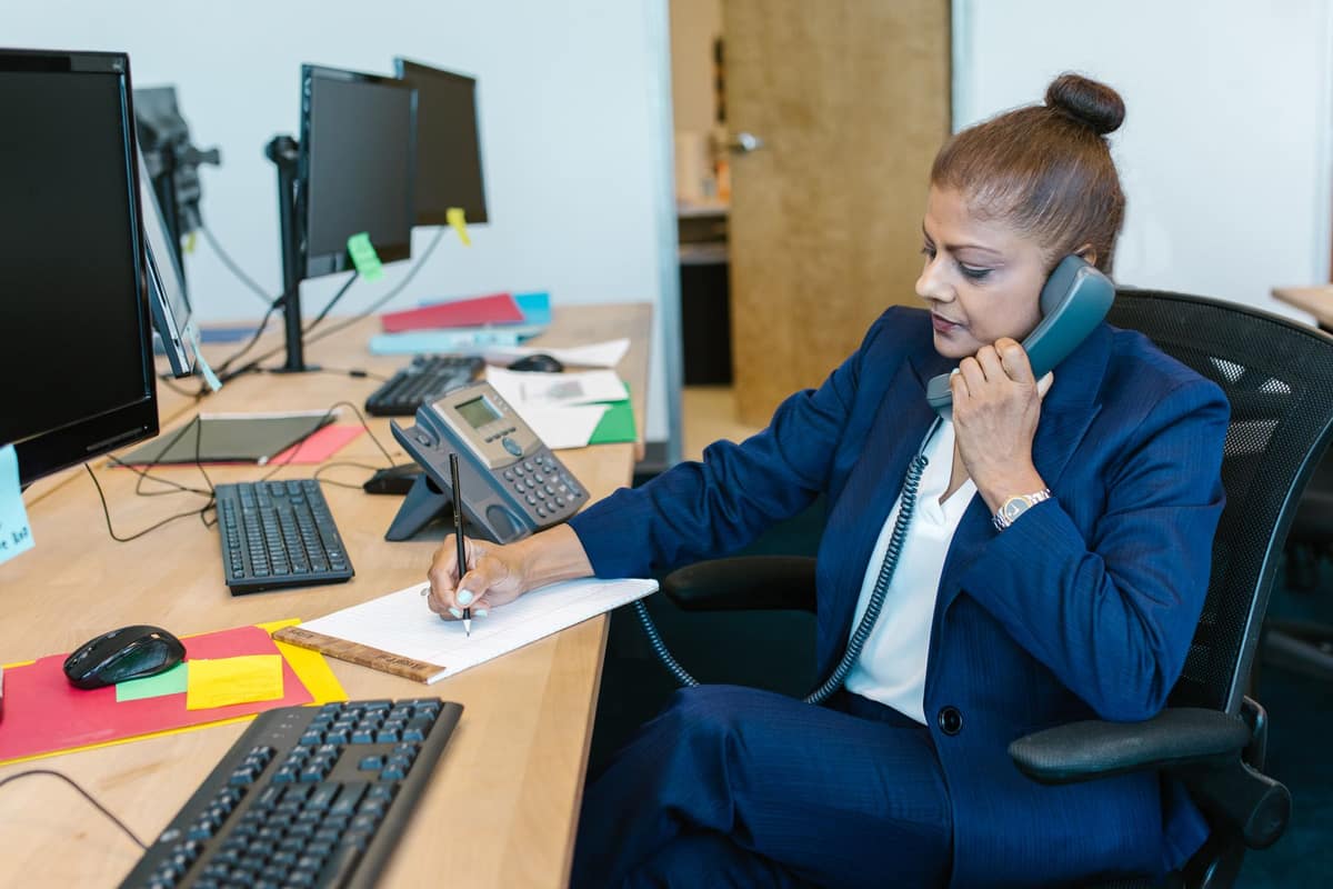 Accounts executive on a call at her desk in an Indian office