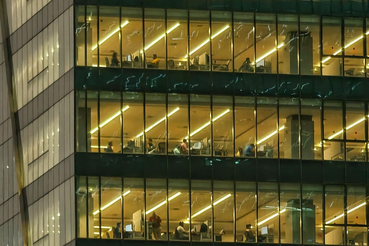 Modern office tower lit up in the evening