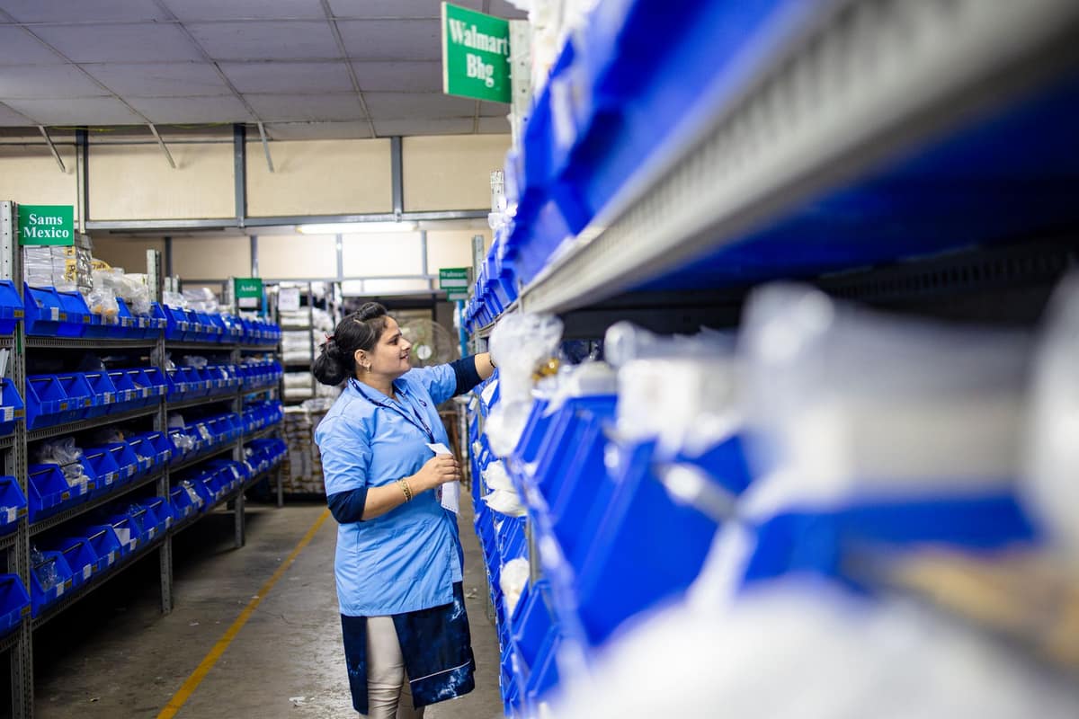 Warehouse worker organising inventory shelves in India