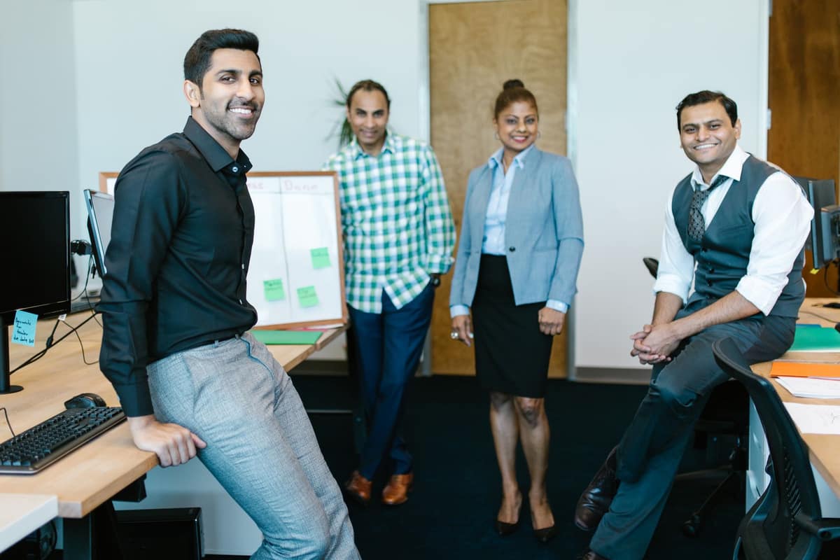 Smiling team of Indian employees in their office