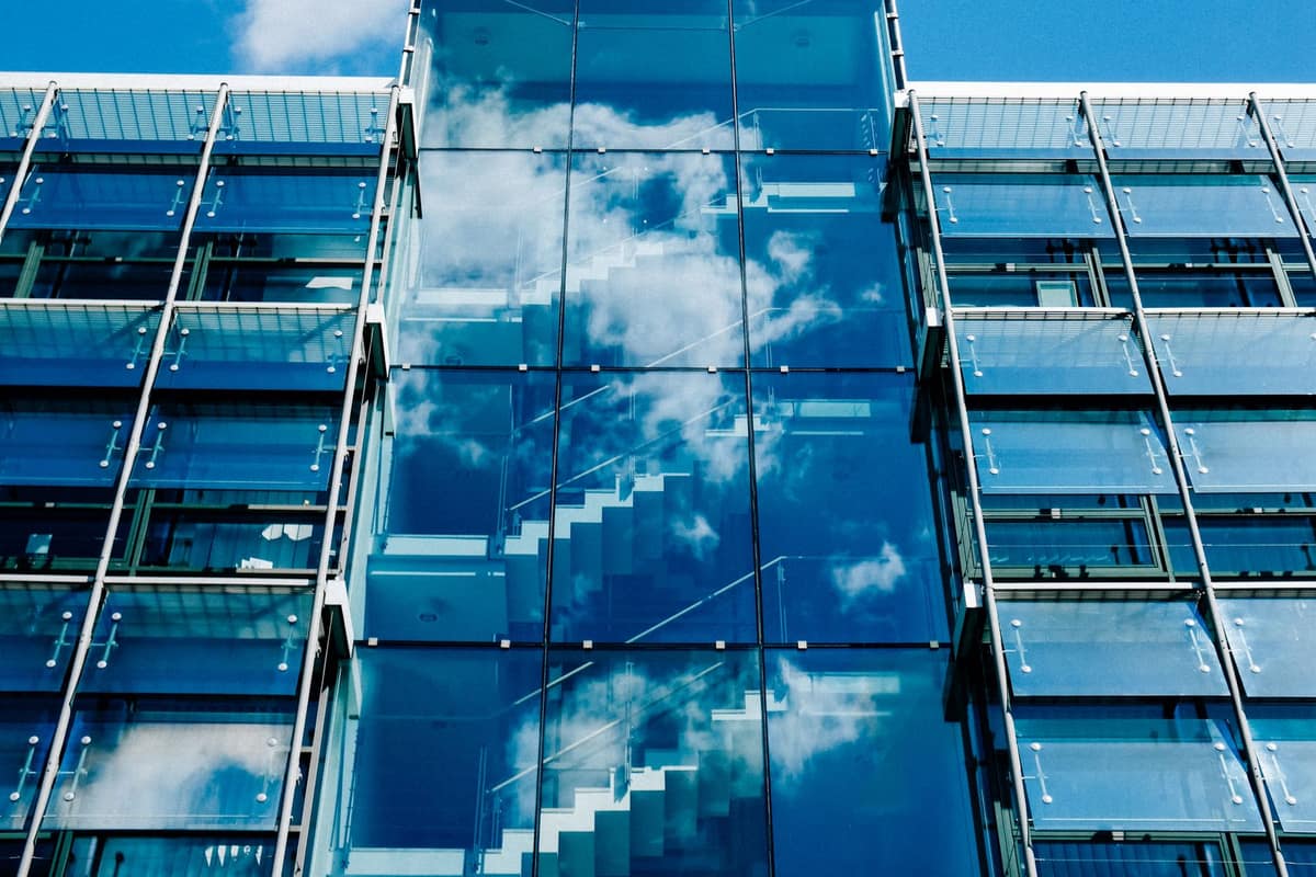 Glass facade of a new office building reflecting the sky
