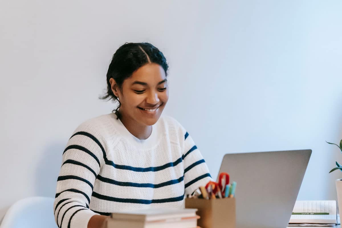 Indian freelancer smiling while working on her laptop