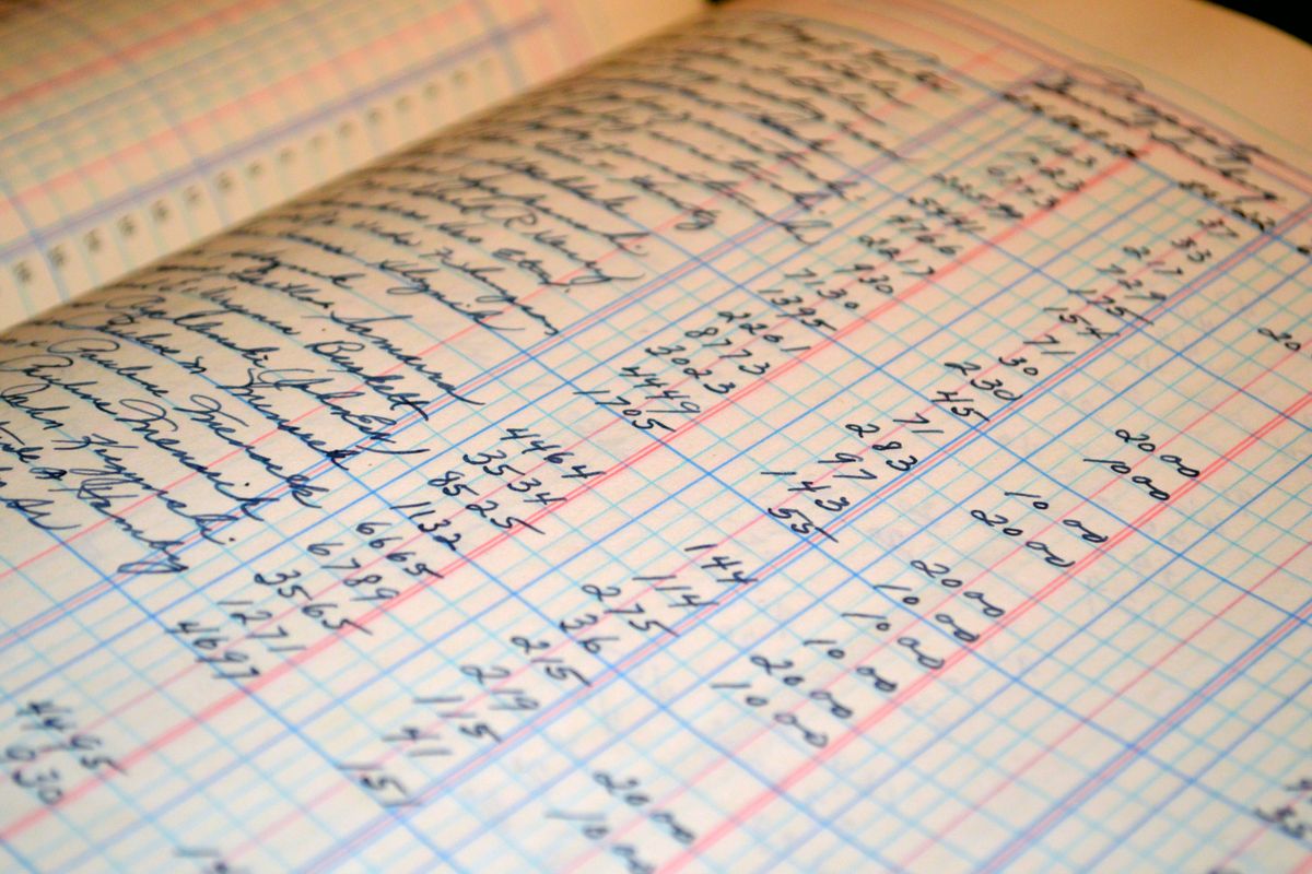 Close-up of a handwritten ledger detailing financial records and accounts.