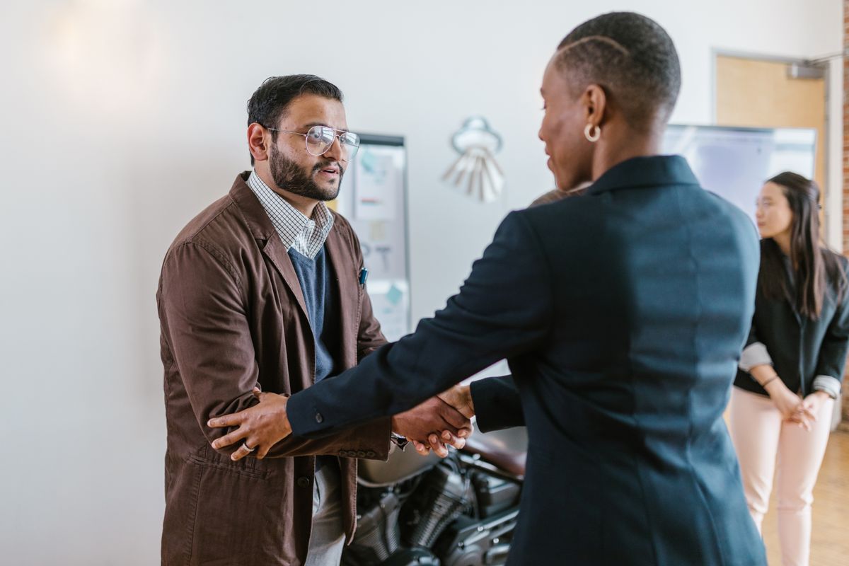 Manager shaking hands with an employee who is leaving the company