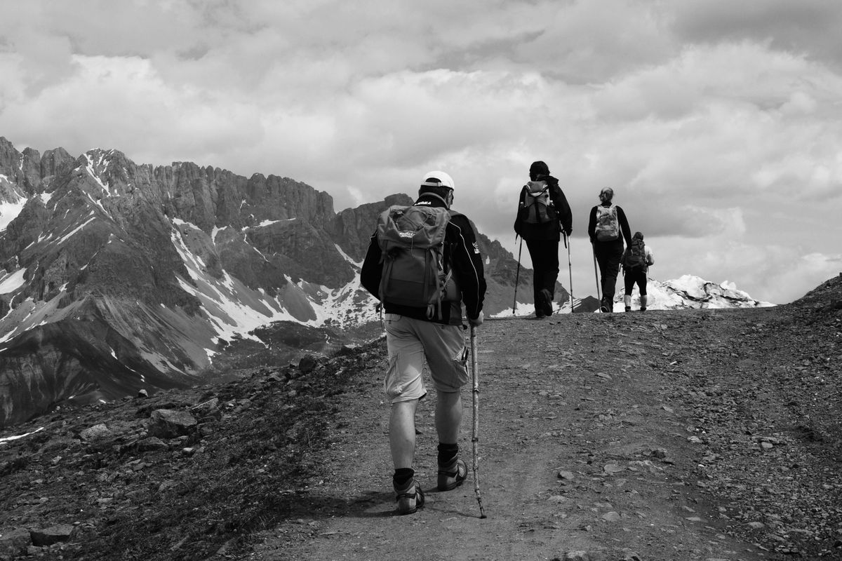 A group of hikers trekking through scenic mountains.