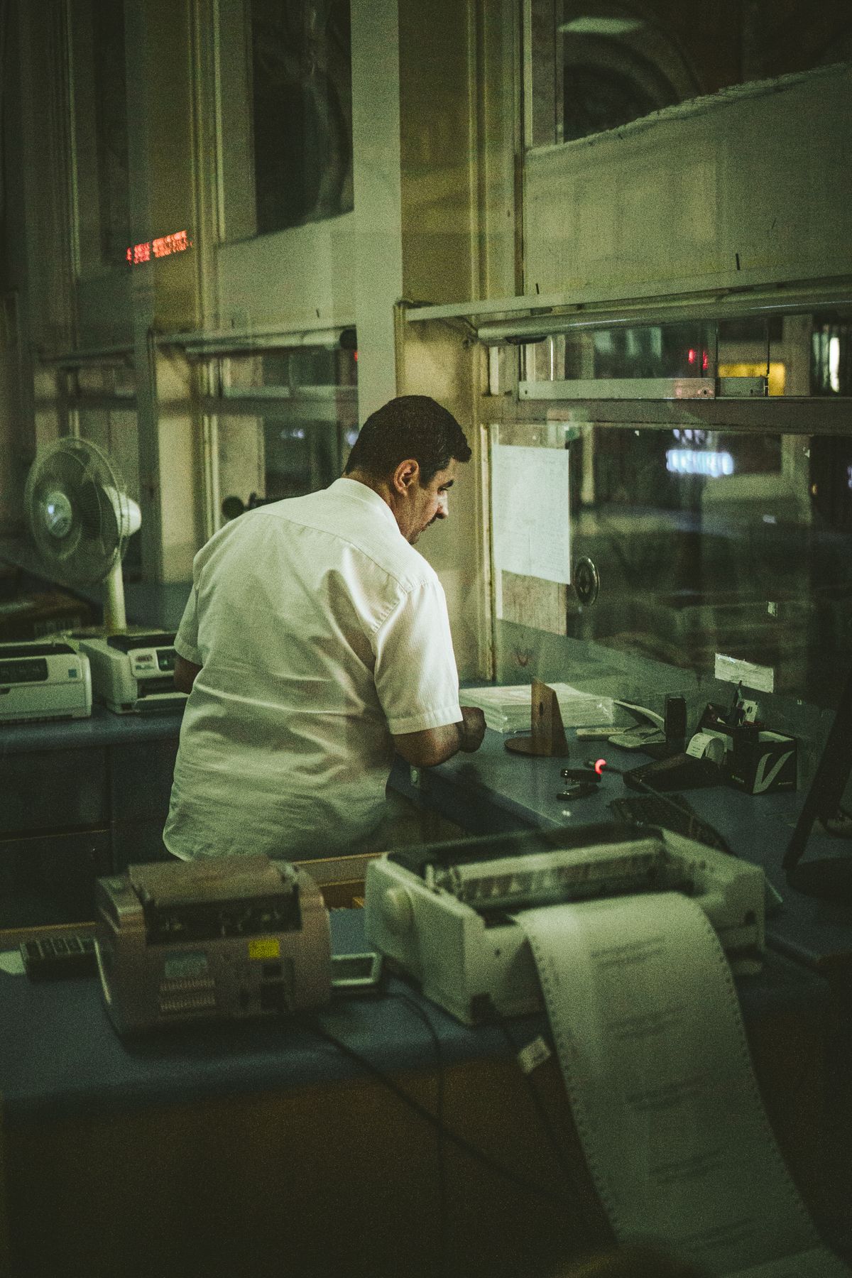 Worker at a control booth during a night shift