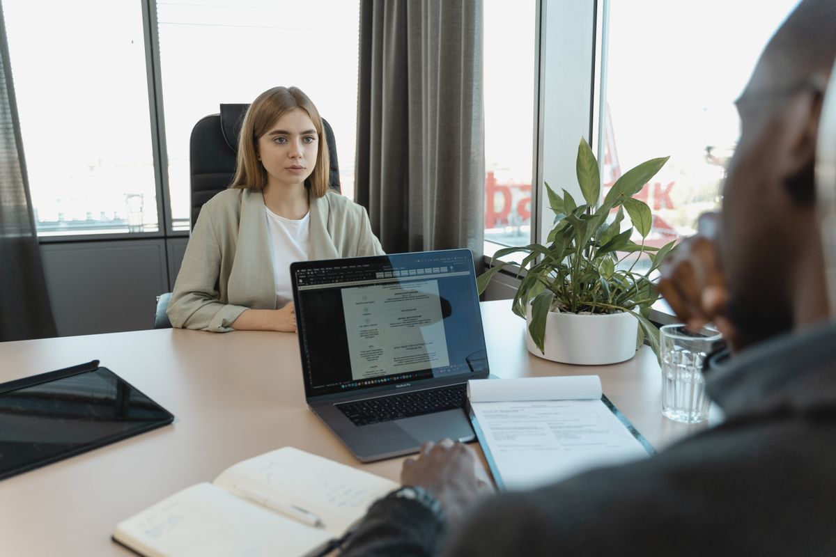 A professional job interview scene in a modern office setting.