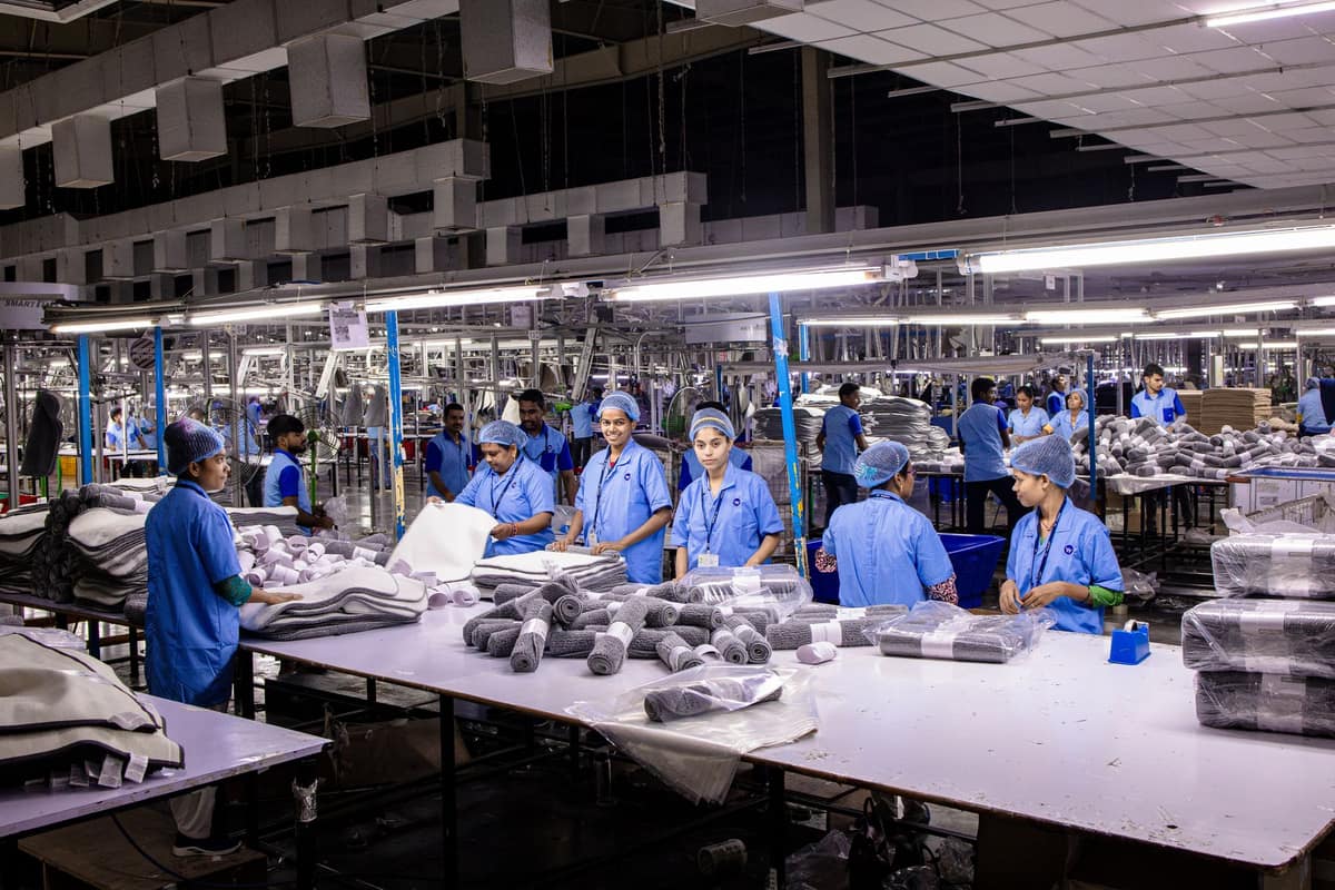 Workers packing products on a large Indian factory floor