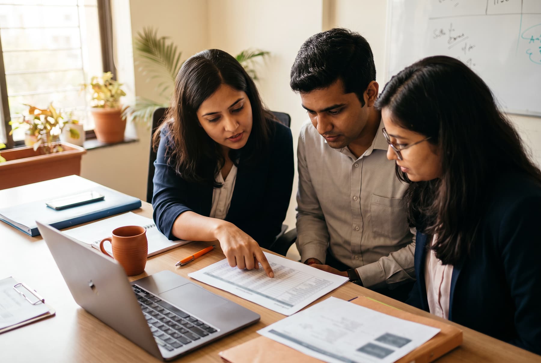A finance team going through month-wise figures for the annual GST return